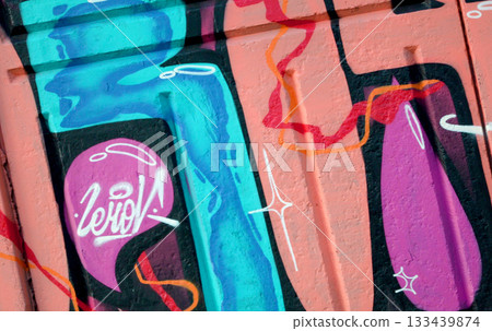 Colorful background of graffiti painting artwork with bright aerosol outlines on wall. Old school street art piece made with aerosol spray paint cans. Contemporary youth culture backdrop 133439874