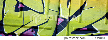 Colorful background of graffiti painting artwork with bright aerosol outlines on wall. Old school street art piece made with aerosol spray paint cans. Contemporary youth culture backdrop 133439881