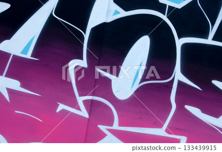 Colorful background of graffiti painting artwork with bright aerosol outlines on wall. Old school street art piece made with aerosol spray paint cans. Contemporary youth culture backdrop 133439915