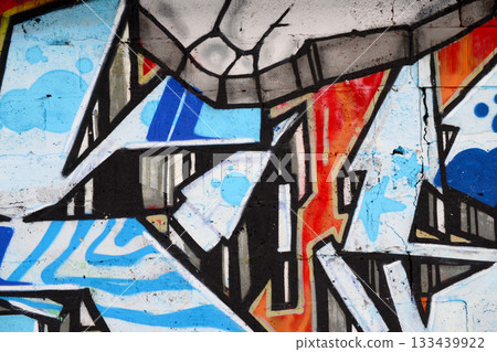 Colorful background of graffiti painting artwork with bright aerosol outlines on wall. Old school street art piece made with aerosol spray paint cans. Contemporary youth culture backdrop 133439922