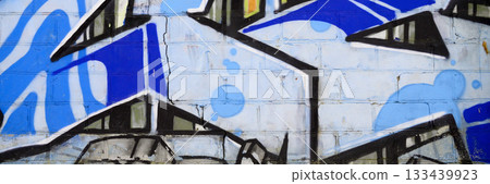 Colorful background of graffiti painting artwork with bright aerosol outlines on wall. Old school street art piece made with aerosol spray paint cans. Contemporary youth culture backdrop 133439923