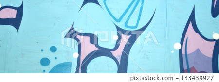 Colorful background of graffiti painting artwork with bright aerosol outlines on wall. Old school street art piece made with aerosol spray paint cans. Contemporary youth culture backdrop 133439927