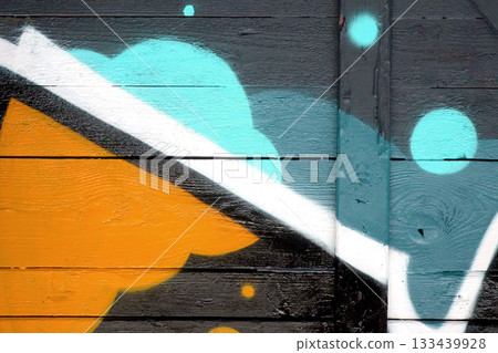 Colorful background of graffiti painting artwork with bright aerosol outlines on wall. Old school street art piece made with aerosol spray paint cans. Contemporary youth culture backdrop 133439928