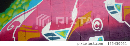 Colorful background of graffiti painting artwork with bright aerosol outlines on wall. Old school street art piece made with aerosol spray paint cans. Contemporary youth culture backdrop 133439931