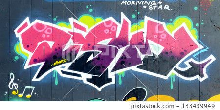 The old wall decorated with paint stains in the style of street art culture. Colorful background of full graffiti painting artwork with bright aerosol outlines on wall. Colored background texture The old wall decorated with paint stains in the style of street art culture. Colorful background of full graffiti painting artwork with bright aerosol outlines on wall. Colored background texture 133439949