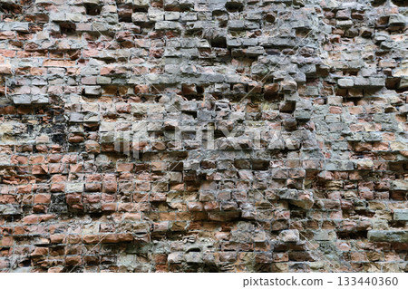 Very old brick stone wall of castle or fortress of 18th century. Full frame wall with obsolete dirty and cracked bricks close up 133440360