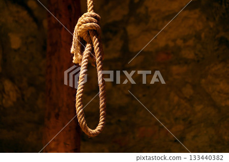 Noose in prison of old castle cellar and grunge stone wall close up Noose in prison of old castle cellar and grunge stone wall close up 133440382