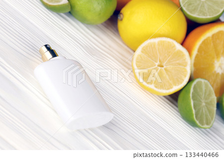 Perfume with citrus extracts. Selective focus. Spa day, concept of freshness perfume bottle with lemon lime and orange slices Perfume with citrus extracts. Selective focus. Spa day, concept of freshness perfume bottle with lemon lime and orange slices 133440466