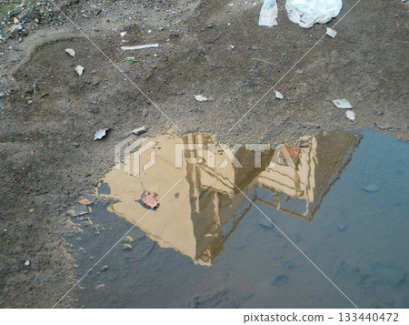 Buildings reflected in a puddle Buildings reflected in a puddle 133440472