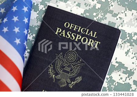 United States official passport book with US flag on camouflage uniform close up. Travel document on camo fabric photo United States official passport book with US flag on camouflage uniform close up. Travel document on camo fabric photo 133441028