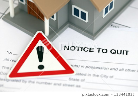 Generic house and eviction notice or notice to quit on table close up Generic house and eviction notice or notice to quit on table close up 133441035