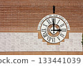 Clock on the wall with votive tablets 133441039