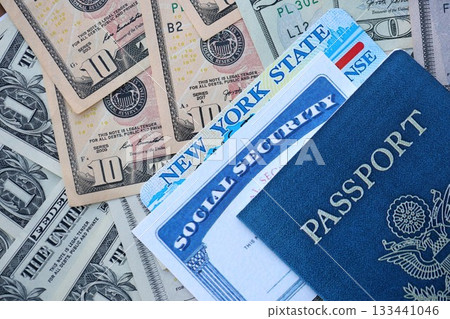 Social security number and New York driving license with passport on US dollar money bills close up 133441046
