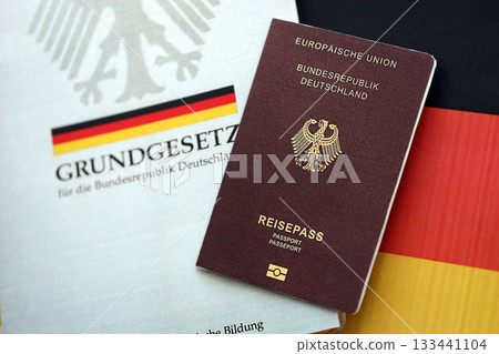 The constitution basic law book of Germany and passport lies on Germany flag background close up The constitution basic law book of Germany and passport lies on Germany flag background close up 133441104