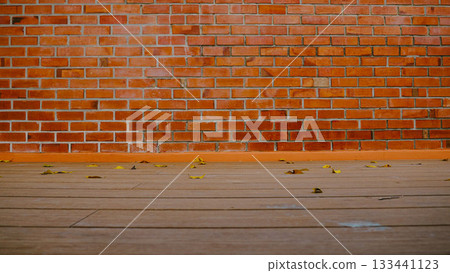 Brick Wall with Wooden Floor and Fallen Leaves Autumn Background Brick Wall with Wooden Floor and Fallen Leaves Autumn Background 133441123