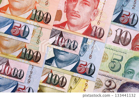 Singapore Dollar currency money bills. SGD currency banknotes in pile with different denomination close up Singapore Dollar currency money bills. SGD currency banknotes in pile with different denomination close up 133441132