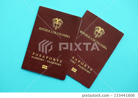 Two colombian passports on light blue table background. Concept of citizenship of Republic Colombia Two colombian passports on light blue table background. Concept of citizenship of Republic Colombia 133441606