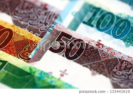 Qatari riyal money bills banknotes lies in big pile on table close up. Concept of finances and business in Qatar 133441619