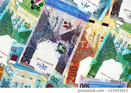 Qatari riyal money bills banknotes lies in big pile on table close up. Concept of finances and business in Qatar Qatari riyal money bills banknotes lies in big pile on table close up. Concept of finances and business in Qatar 133441623