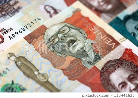 Colombian pesos money bills banknotes lies in big pile on table close up. Concept of finances and business in Colombia Colombian pesos money bills banknotes lies in big pile on table close up. Concept of finances and business in Colombia 133441625