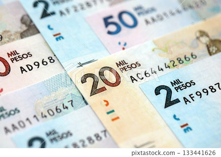 Colombian pesos money bills banknotes lies in big pile on table close up. Concept of finances and business in Colombia 133441626