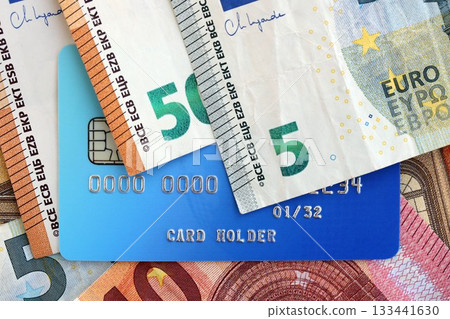 Euro money bills banknotes and credit card for cashless payments. Concept of banking service in European Union countries Euro money bills banknotes and credit card for cashless payments. Concept of banking service in European Union countries 133441630