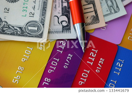 Credit cards and pen with US dollar currency money bills banknotes. Business, financial operations and accounting in United States of America Credit cards and pen with US dollar currency money bills banknotes. Business, financial operations and accounting in United States of America 133441679