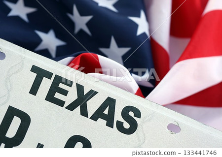 USA state of Texas license plate on US flag. Concept of driving in Texas. Reaching a driving permit USA state of Texas license plate on US flag. Concept of driving in Texas. Reaching a driving permit 133441746