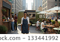 Smiling woman owner standing in front of urban food truck cafe with customers. 133441992