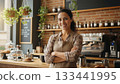 Owner of small business smiling while standing with arms crossed in her cafe. 133441995