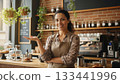 Owner of small business smiling while standing in her cafe. 133441996
