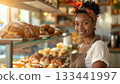 Happy business owner working in artisanal bakery shop selling fresh pastries. 133441997