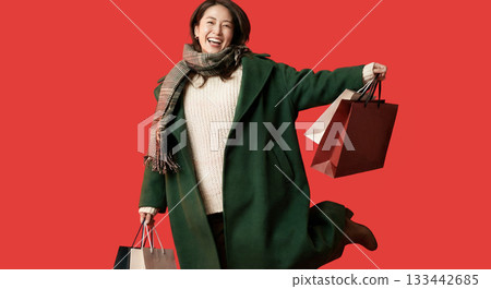 AI-generated image of Black Friday: Portrait of a young woman holding a shopping bag against a red background 133442685