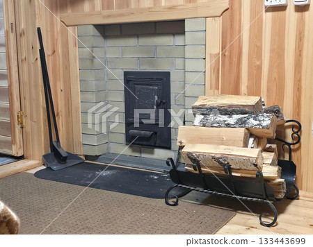Warm sauna Lounge with Brick Stove and Firewood Rack 133443699