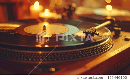Elegant vintage turntable spinning vinyl record on wooden surface in warmly lit retro music studio with candles and nostaic ambiance Elegant vintage turntable spinning vinyl record on wooden surface in warmly lit retro music studio with candles and nostaic ambiance 133446100