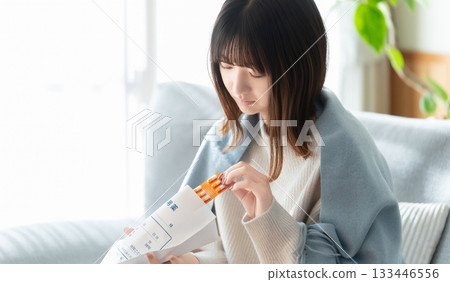 Unwell woman taking medicine Unwell woman taking medicine 133446556