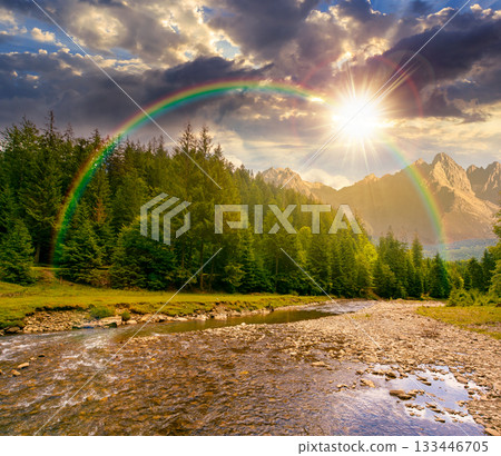 landscape with mountains, forest and a river in front at sunset. beautiful scenery in summer in evening light. water flowing through ecology and sustainability storytelling image under the rainbow 133446705