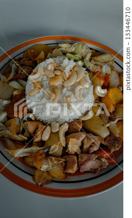 Nutritious plate of Moo pad med mamuang himmaparn or pork fried with cashew nuts with rice, traditional thai food. Bangkok, Thailand Nutritious plate of Moo pad med mamuang himmaparn or pork fried with cashew nuts with rice, traditional thai food. Bangkok, Thailand 133446710
