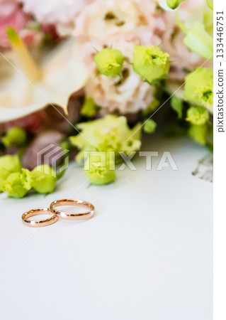 pair of gold wedding rings lie on white paper pair of gold wedding rings lie on white paper 133446751