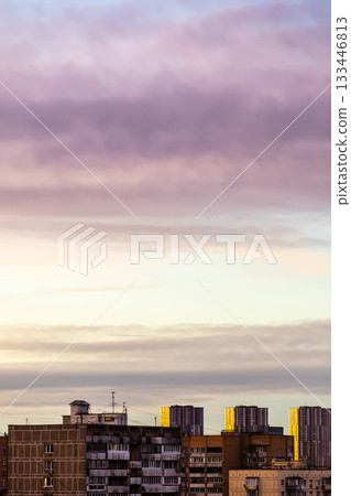 pink gray, yellow cloudy sky over urban houses 133446813