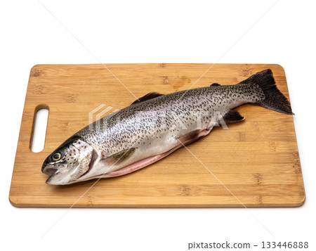 A fish is on a wooden cutting board 133446888