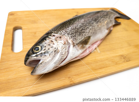 A fish is on a wooden cutting board 133446889