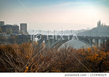 A bridge over a river with a city in the background A bridge over a river with a city in the background 133446929