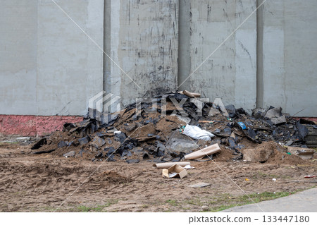 Roofing felt pile, sand and other construction waste against the wall of a building, building reconstruction, waste sorting, Roofing felt pile, sand and other construction waste against the wall of a building, building reconstruction, waste sorting, 133447180