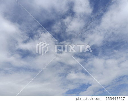 Soft white cloud spread across pale blue sky creating calm airy atmosphere with gentle light and soft texture 133447317