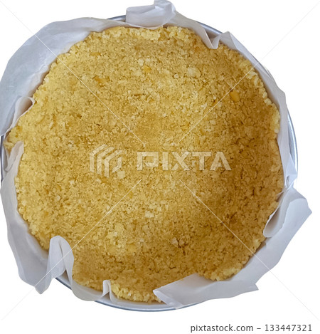 Crumbly shortbread crust in round pan with parchment paper, warm golden texture and homemade feel 133447321