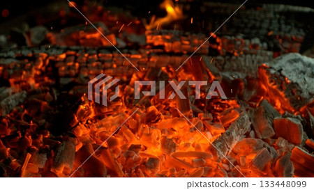 Close-up of Hot Embers with Flying Sparks . Concept of heating grills or ovens 133448099