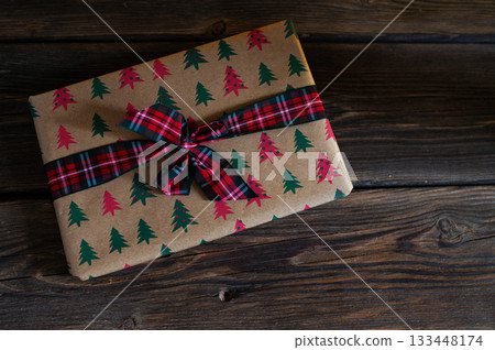 Cozy Christmas Interior with Fireplace, Gift Boxes, and Decorated Tree with Warm Lights 133448174