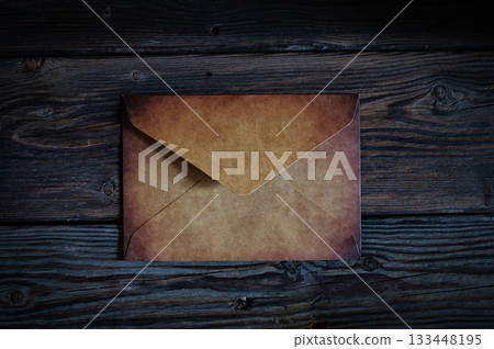 Vintage quill pen and empty old blank paper sheet with rose petals on wooden background from above. Romantic letter concept 133448195
