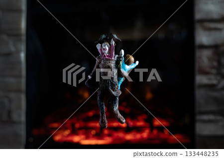 Krampus Ornament Carrying Child Hanging on Advent Garland Above Fireplace 133448235